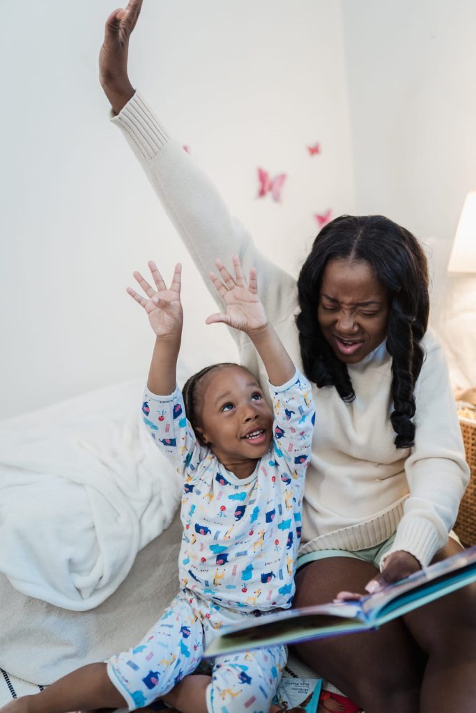daughter and mom having fun with book