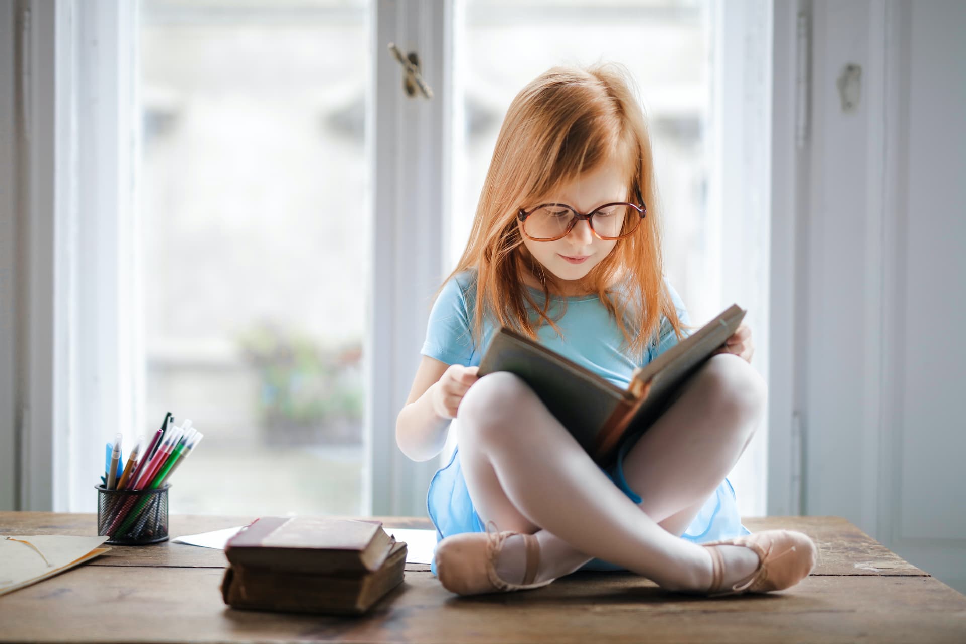 little girl reading a classic childrens book