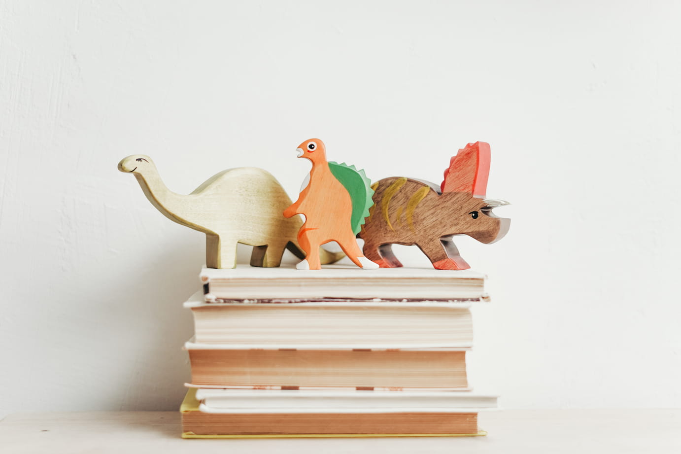 nonfiction books with dinosaur toys on top